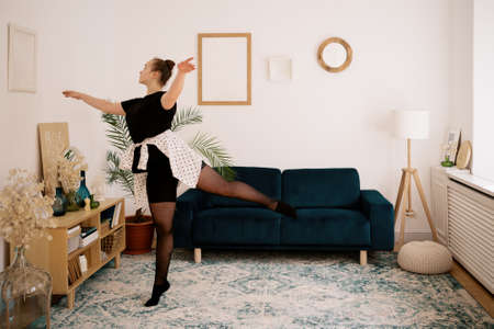 Teenager girl practicing ballet online classes at home. Woman dancing indoorsの写真素材