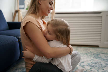 Togetherness Concept. Daughter hugging her mum. Love family, parenthood childhood concept. Mom and her kid playing togetherの写真素材