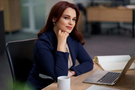 Caucasian woman working laptop. Business woman busy working on laptop computer at office.の写真素材