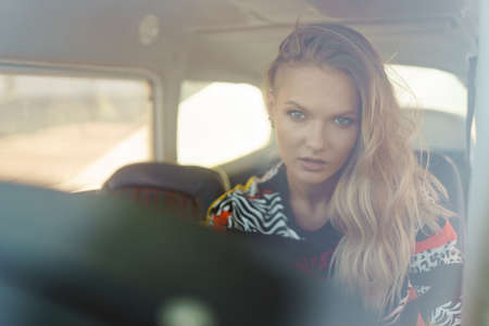 Young woman ready to fly, start training, looking through airplane window while waiting the pilot