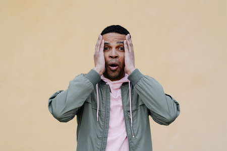 Surprised and screaming man. Emotional man on yellow background. Emotional face. Human emotions,...