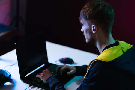 Portrait of Software Developer. Hacker. Gamer Wearing Headset Sitting at His Desk and Working....