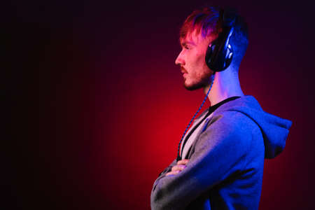 Neon portrait of a bearded man in headphones, wearing parkaの写真素材