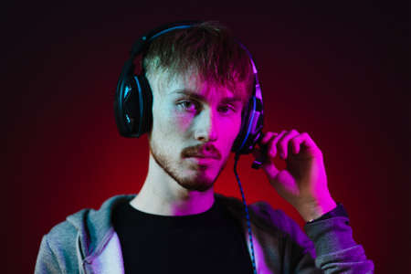 Neon portrait of a bearded man in headphones, wearing parkaの写真素材