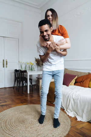 Happy couple moving in a new house having fun and celebratingの写真素材