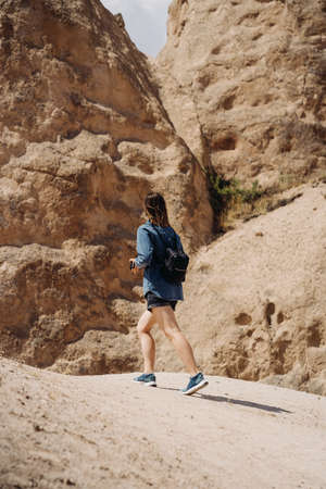 Wanderlust and travel concept. Women traveler on top of mountains, amazing view. Casual woman hiking. Atmospheric momentの写真素材