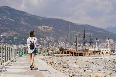 Turkey travel tourist woman on vacation in the Alanya walking on embankment. Turkey summer destination.の写真素材