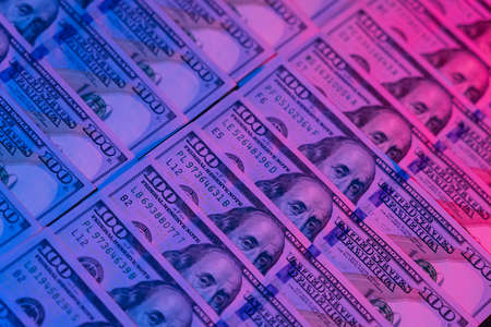 Money background. Dollars lighted by blue and red. Financial market