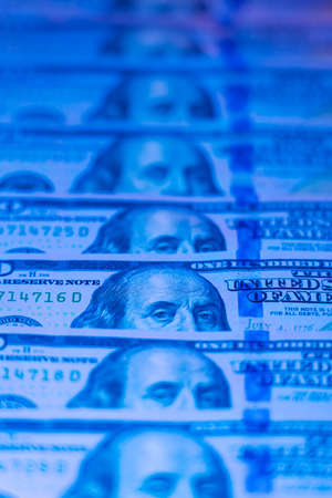 Money background. Dollars. Finance and wealth in blue neon lightの写真素材