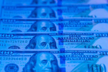 Money background. Dollars. Finance and wealth in blue neon lightの写真素材