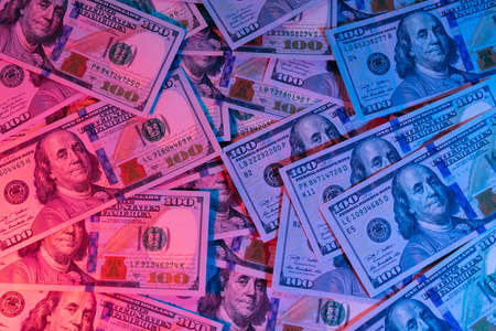 Money background. Dollars lighted by blue and red. Financial marketの写真素材
