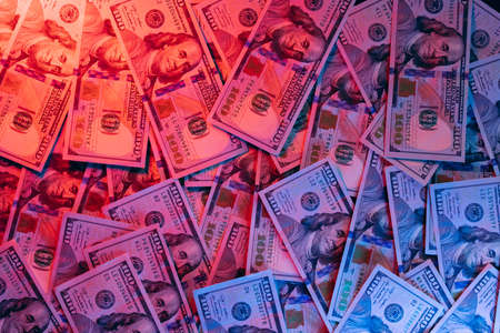 Money background. Dollars lighted by blue and red. Financial market