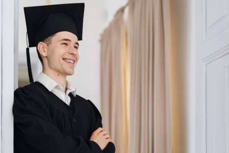 Education, graduation and people concept - happy male student at home showing his emotionsの写真素材