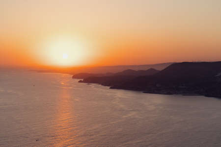 Beautiful abstract nature background with sea orange sunset on the coastlineの写真素材