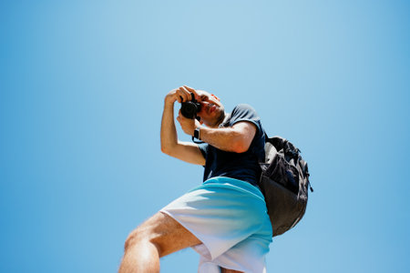 Tourist taking photo on blue sky background. Summer vacationの写真素材