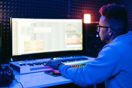 Producer, audio engineer uses a control panel and screen to record a track of a new album in a recording studio, in a soundproof room. Image producer, designer in working processの写真素材