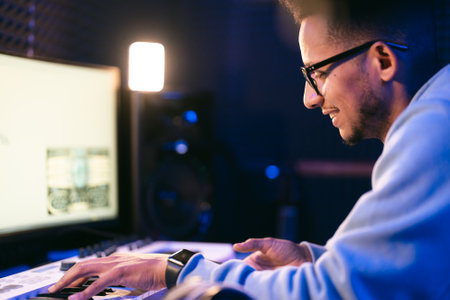 Producer, audio engineer uses a control panel to record a track of a new album in a recording studio, in a soundproof room. Image producer, designer in working processの写真素材