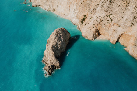 Seascape and sandy beach with turquoise clear waters and trees in Greece