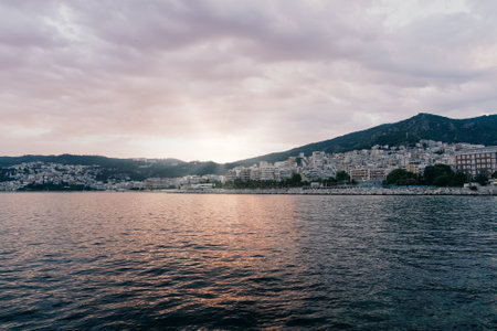 KAVALA, GREECE - July 7, 2022: Seascape with turquoise clear waters, city and sky in Greece....