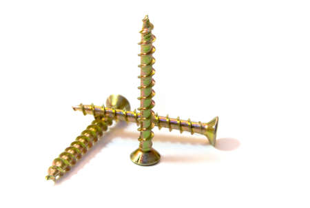 Three zinced screws, are photographed on a white background