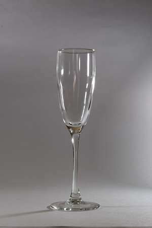 Glass champagne glass, on a light gray background. Glassware on the background of Whatman.の写真素材
