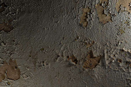 The texture of cracked paint on the wall of an old crumbling building. The textured wall of a very...
