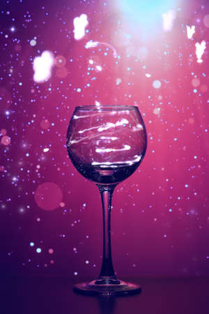 Shining lights in a transparent glass glass. The shining lights of garlands in a glass glass create a festive mood. Beautiful, transparent glass, shining, Merry Christmas and happy New Year.の写真素材
