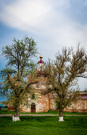 An old church, destroyed by time, in the village. An ancient church being restored, in a distant village.の写真素材
