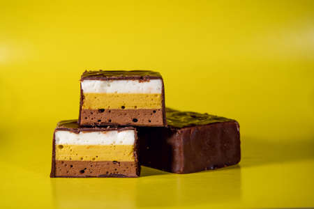 Candy made of multi-colored, puff souffle, covered with chocolate. Multi-colored, puff, sweet...
