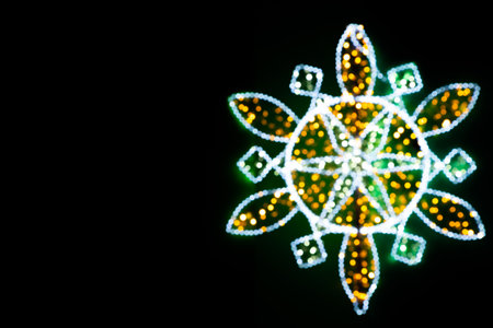 Christmas decoration in the form of a Christmas star from garlands. Bokeh of bright lights, in the form of a Christmas star.の写真素材