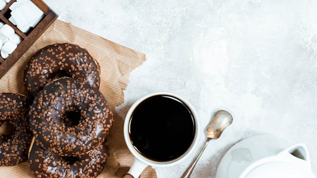 Chocolate donuts and coffee , weekend morning table breakfast. Vintage colorsの写真素材