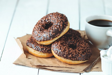 Chocolate donuts and coffee , weekend morning table breakfast. Vintage colorsの写真素材