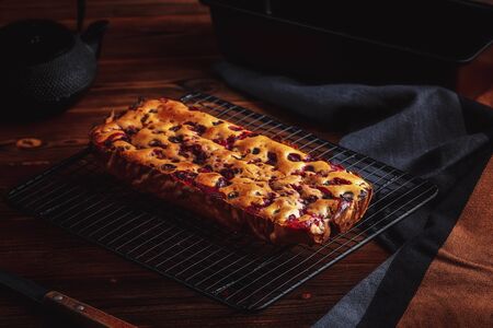 Fresh moist homemade delicious raspberry cake on black cooling rackの写真素材