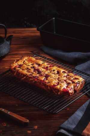 Fresh moist homemade delicious raspberry cake on black cooling rackの写真素材