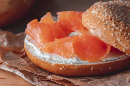 Fresh made Bagel with Salmon on old wooden table