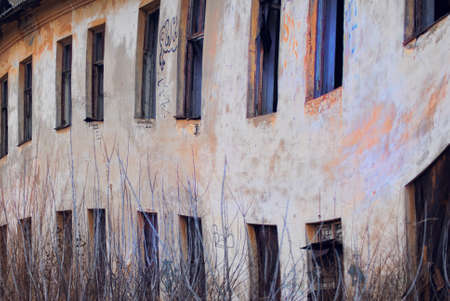 A dilapidated wall of abandoned barracksの写真素材