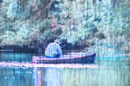 A lone fisherman in a boat.の写真素材