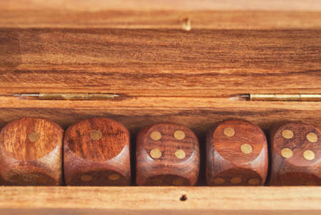 Set of dice in a wooden box close-upの写真素材