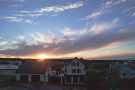Sunset against the background of beautiful clouds in the suburbs.の写真素材
