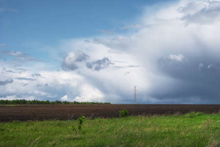 Beautiful rain clouds over the green fields of Russia.の写真素材