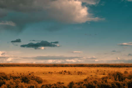 View from the hills to the valley with sparse clouds.の写真素材