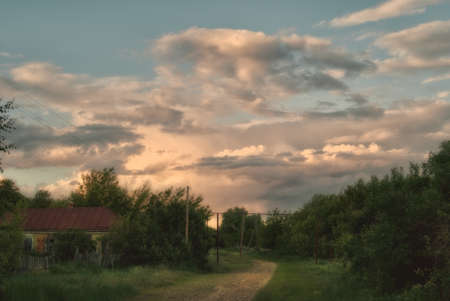 The storm clouds approaching the village green street