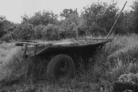Old Russian carriage against the background of green grass. Cart. Drayの写真素材