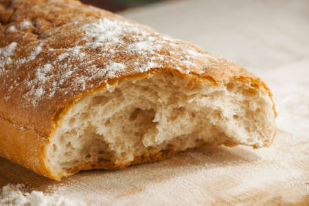 White wheat fresh ruddy bread on a blackboard closeup.
