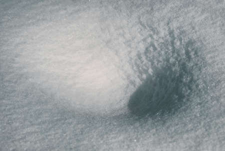The texture hollow of the February snow and snowdrifts close-upの写真素材