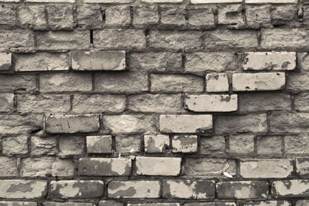 Texture of brick wall with cracked weathered structure white gray color close-up .