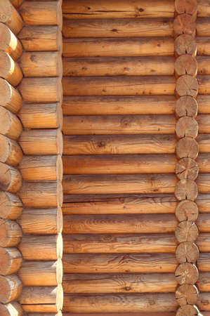 Texture in parallel folded logs. The ancient technology of building a Russian log hut cottages and churches. Treated timber wood.の写真素材