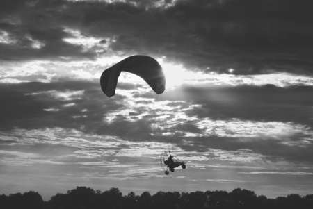 Flying in the sky at a paraglider manの写真素材