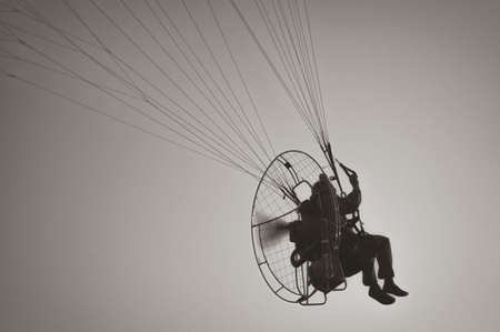 Flying in the sky at a paraglider manの写真素材