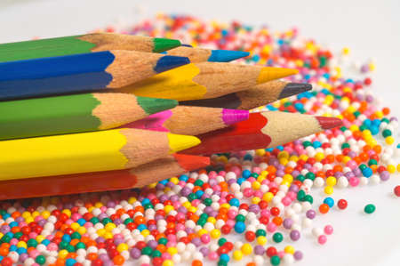 Color pencils on the background of the texture of multi-colored balls close-up. A set for children's...